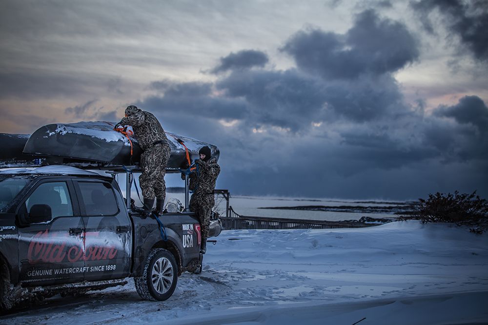 Canoe duck hunting in the cold snow