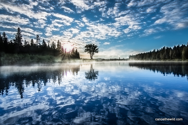 Long Lake Dam in Maine surrounded by morning fog. 