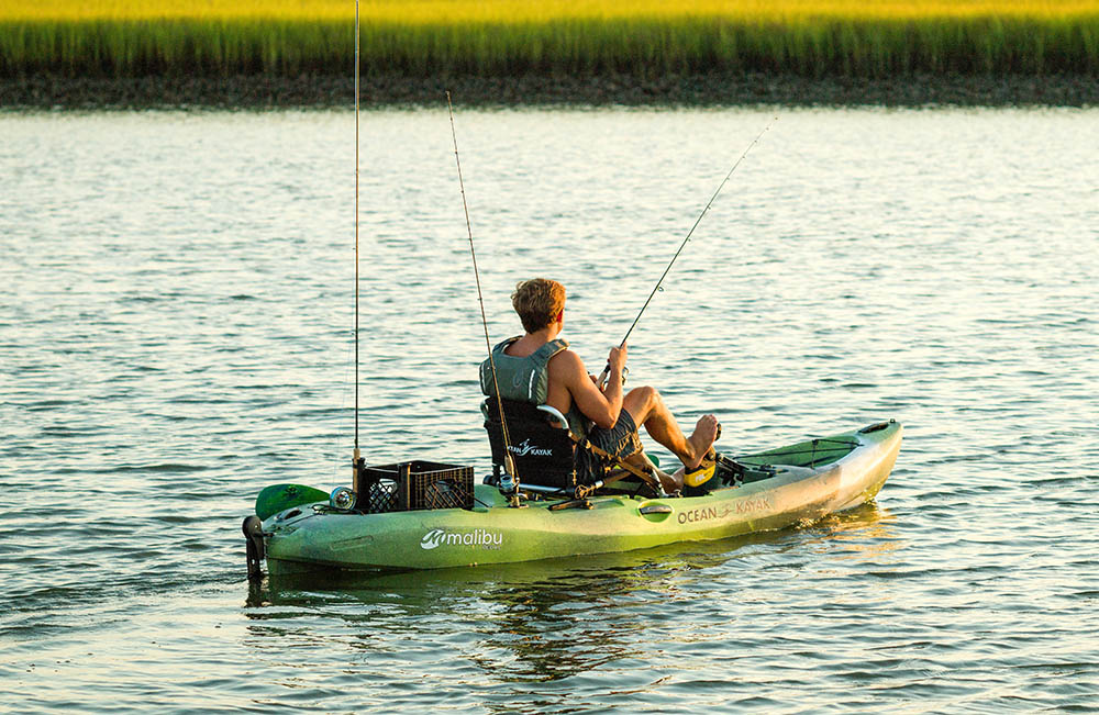 Man in Ocean Kayak Malibu Pedal kayak fishing out on the water