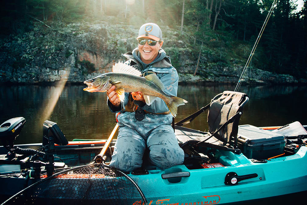 Smiling guy holding up large fin fish caught in the Old Town Sportsman Autopilot Kayak