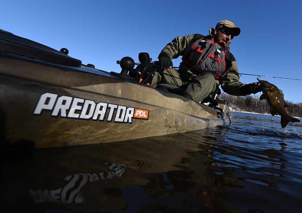 Paul Hansen catching a bass fish from his Predator PDL kayak