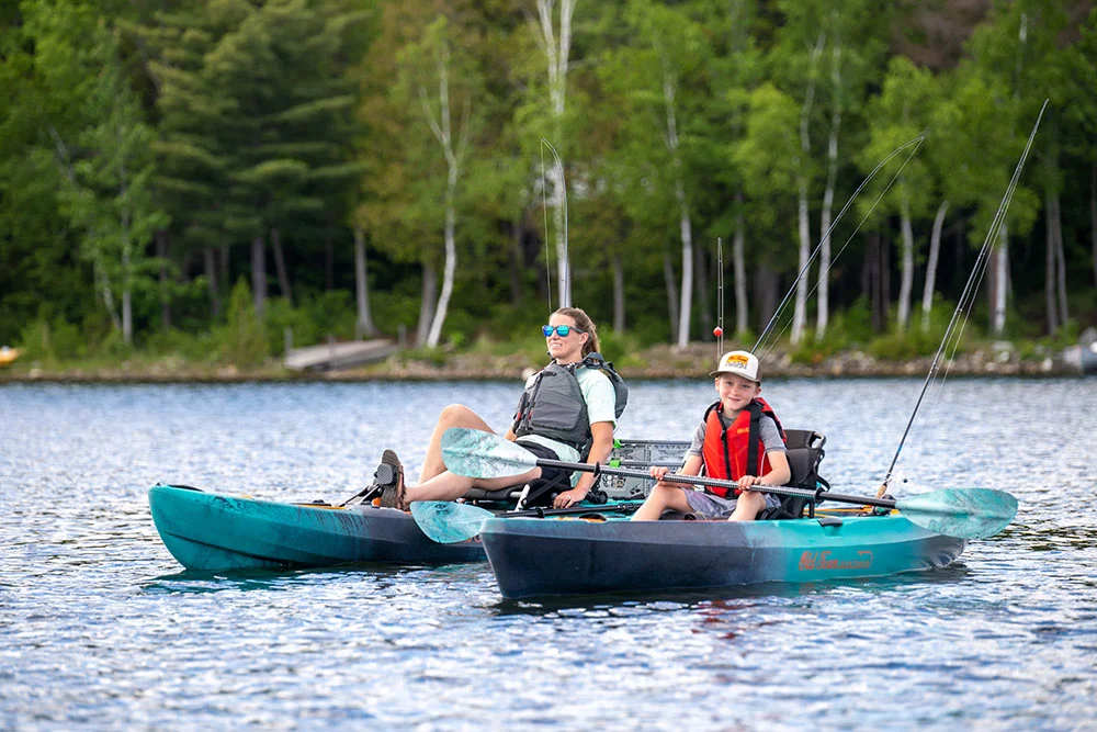 Woman and kid in Old Town Sportsman PDL and Paddle kayaks