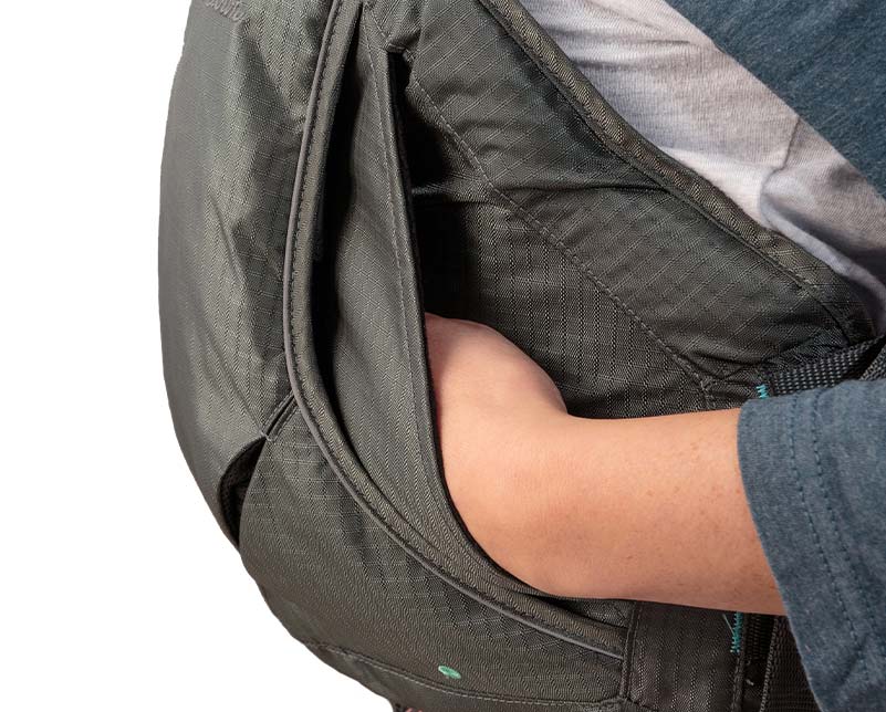 Hands resting in hand warmer pocked on the Old Town Solitude II Life Jacket