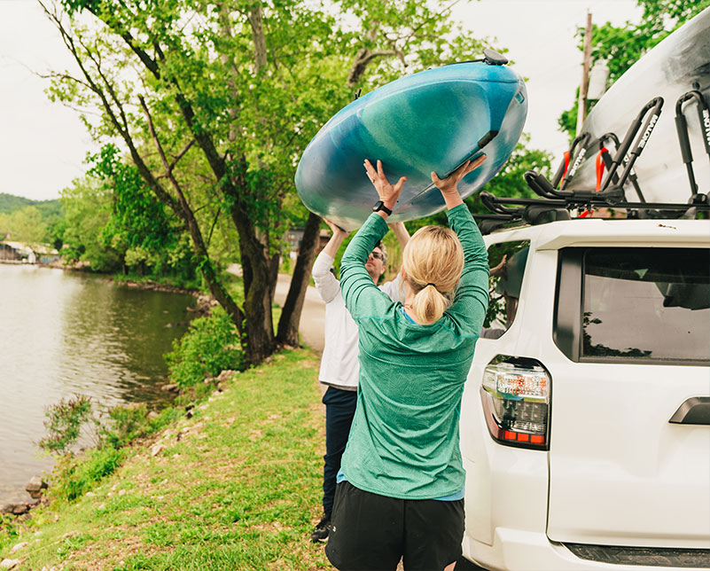 Lifting Old Town Breeze kayak on top of truck for transportation