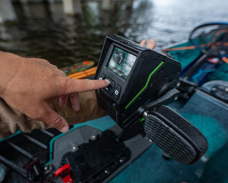 Finger using the Old Town ePDL+ RetroFit console screen on sportsman kayak