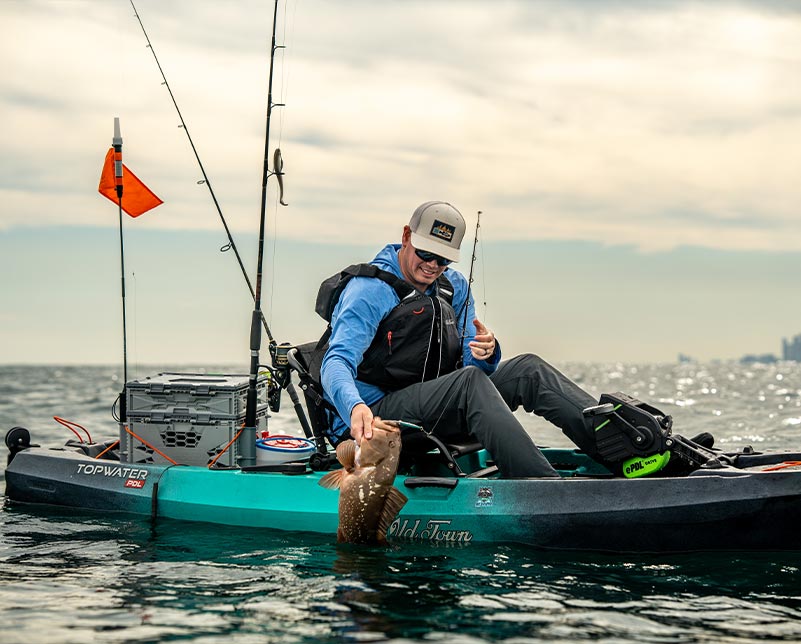 Man pulling up caught fish in the Old Town Topwater PDL with ePDL+ Retrofit Console installed