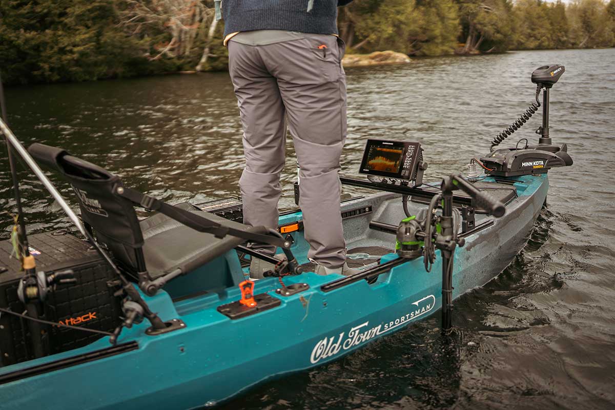 Person standing up in a rigged out Old Town 120 PRO fishing kayak
