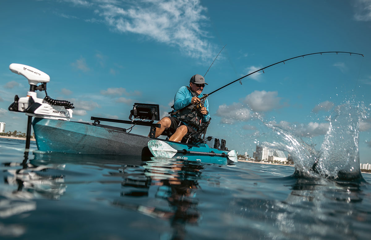 Man fishing from Old Town Sportsman 120 PRO fishing kayak with Minn Kota Kayak Trolling Motor and Fish finder