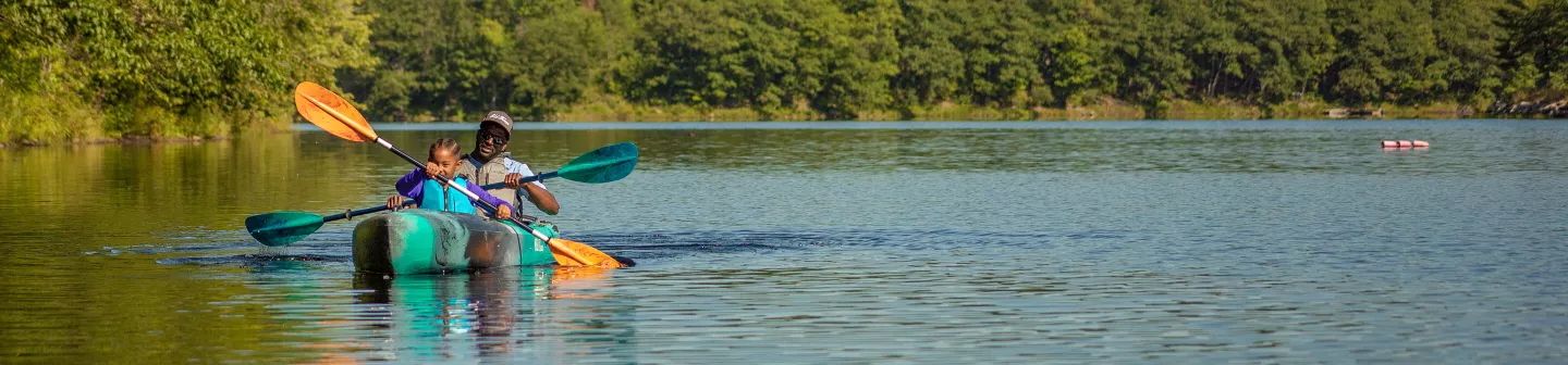 Old Town recreational kayaks father daughter paddling tandem kayak on river