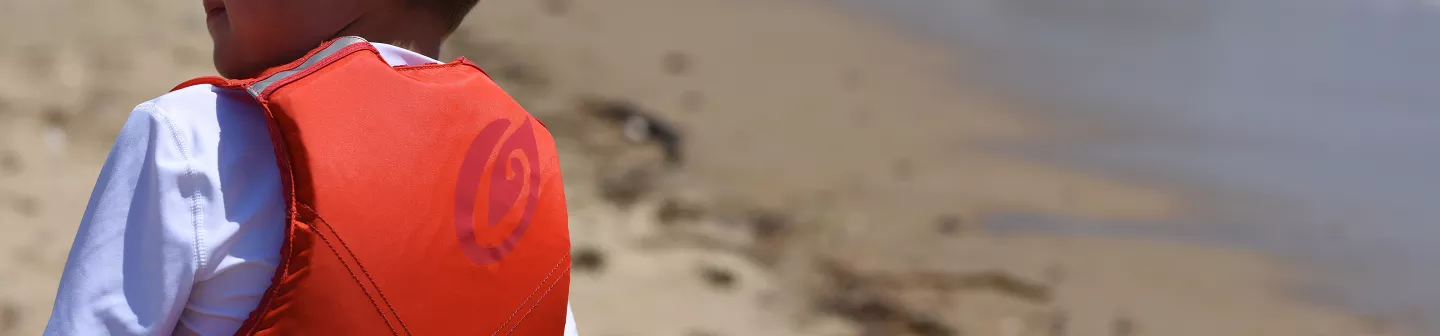 Close-up of child wearing a red Old Town life jacket