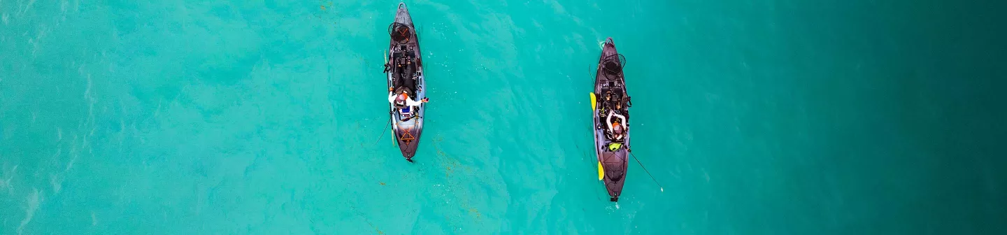 Two people fishing in the Old Town Sportsman BigWater ePDL+ 132 Fishing Kayaks