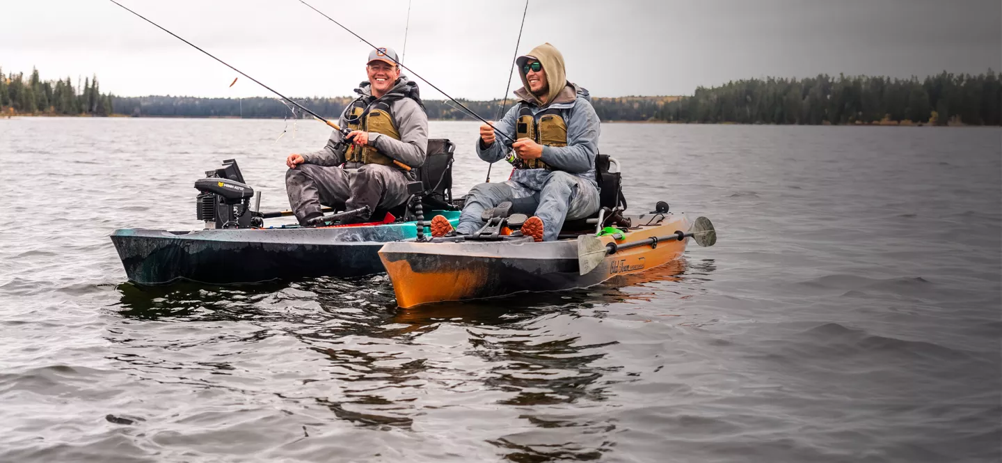 Two happy men fishing in Old Town Sportsman fishing kayaks