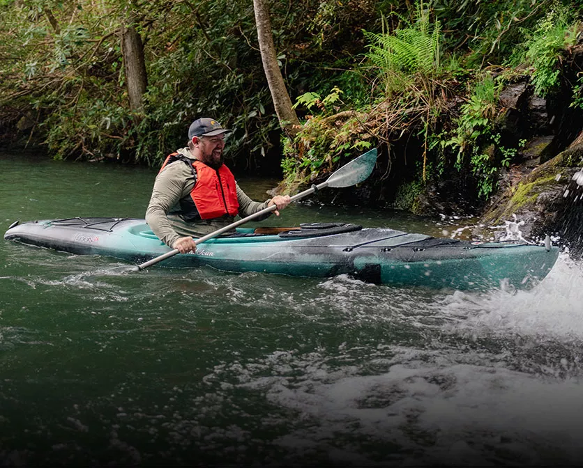 Happy Man paddling in the Old Town Loon Rec Kayak