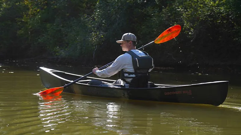 Man paddling with Carlisle paddle in Old Town Sportsman Solo 119 Canoe
