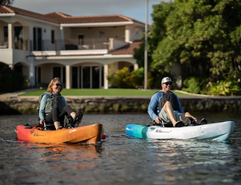 Couple pedaling in Old Town Ocean Kayak Malibu ePDL+ 120 recreational kayaks