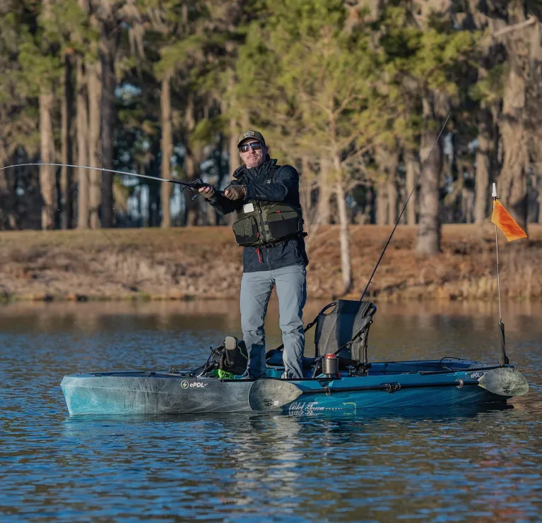 Man standing up and fishing in the Old Town Sportsman ePDL+ 120 Pro fishing kayak
