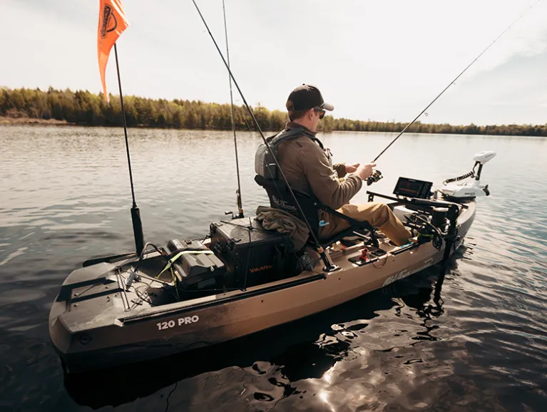 Man fishing from a tan Old Town Sportsman 120 PRO