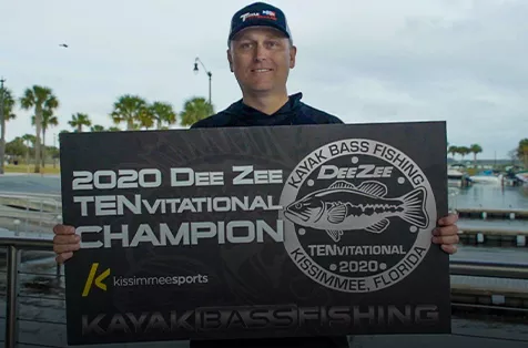 Allen Sweat holds a large winners check for a bass tournament