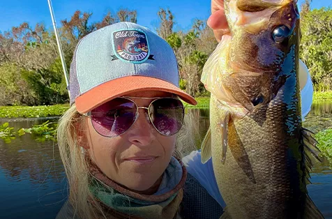 Wendy Biles holds up a largemouth bass.